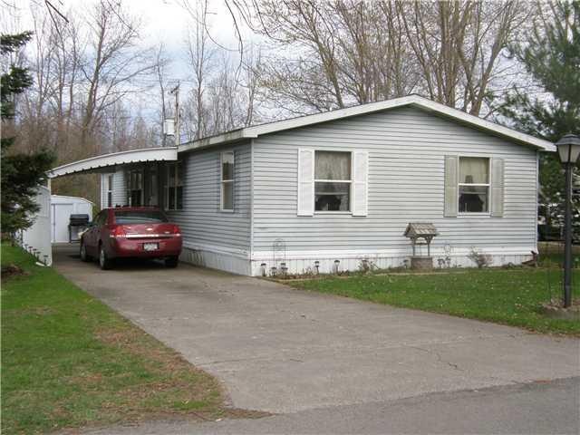 Exterior Front Situated between evergreen trees an