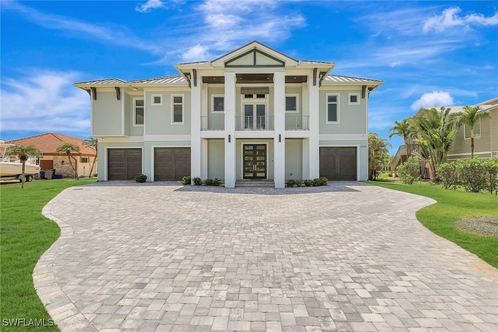 View of front of house with a garage, a standing s