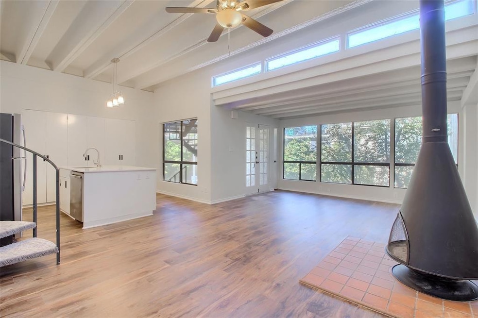 Unfurnished living room featuring beam ceiling, a
