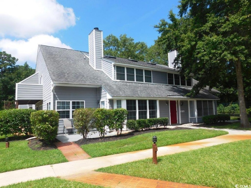 Traditional home with a front yard, roof with shingles, and a chimney