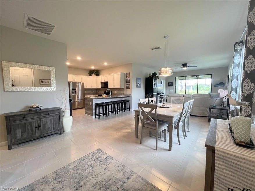 Tiled dining room featuring sink and ceiling fan