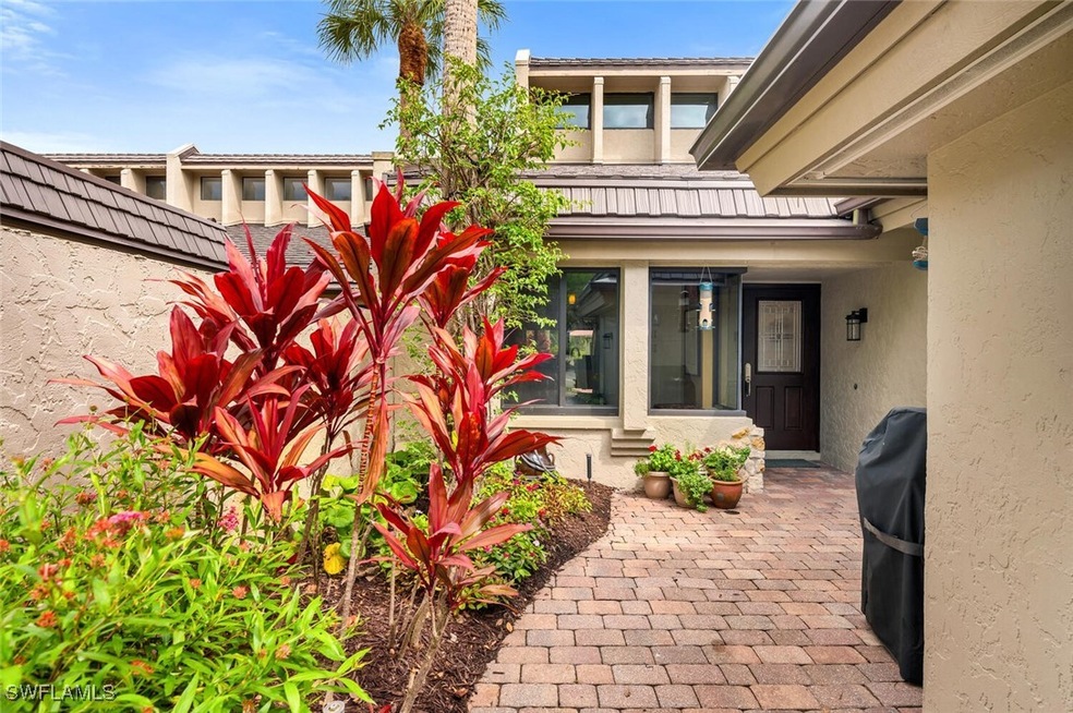 Entrance to property featuring fence and stucco si