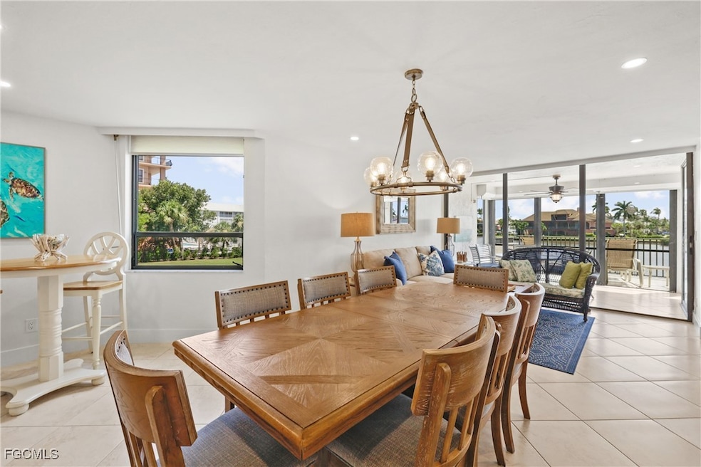 Dining room with recessed lighting, light tile patterned floors, a chandelier, and ceiling fan