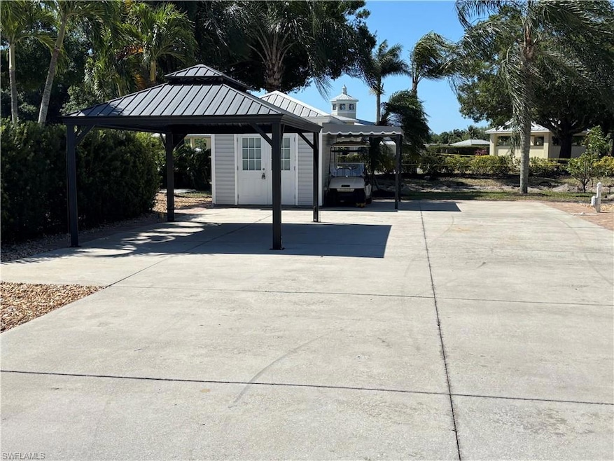 Surrounding community with driveway and a carport