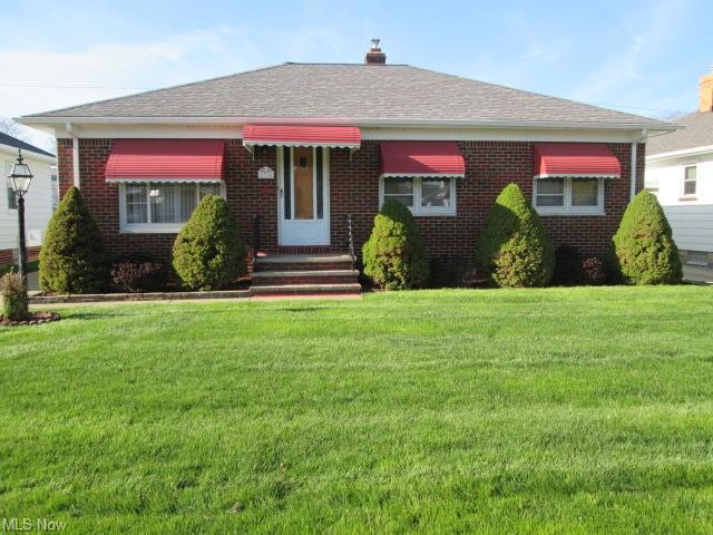 Front with well maintained yard