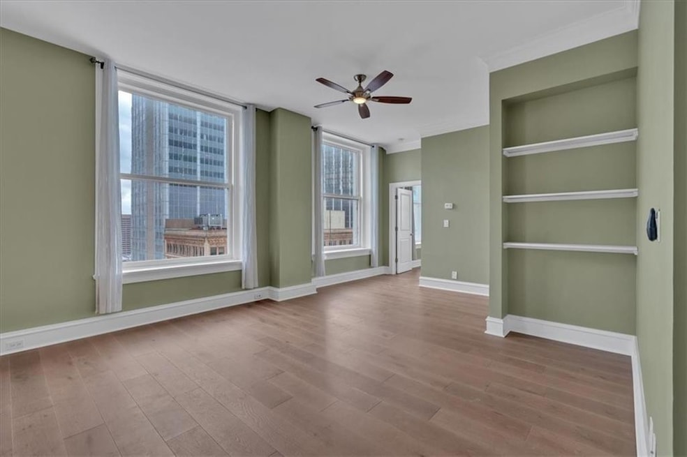 Empty room with built in features, ceiling fan, cr