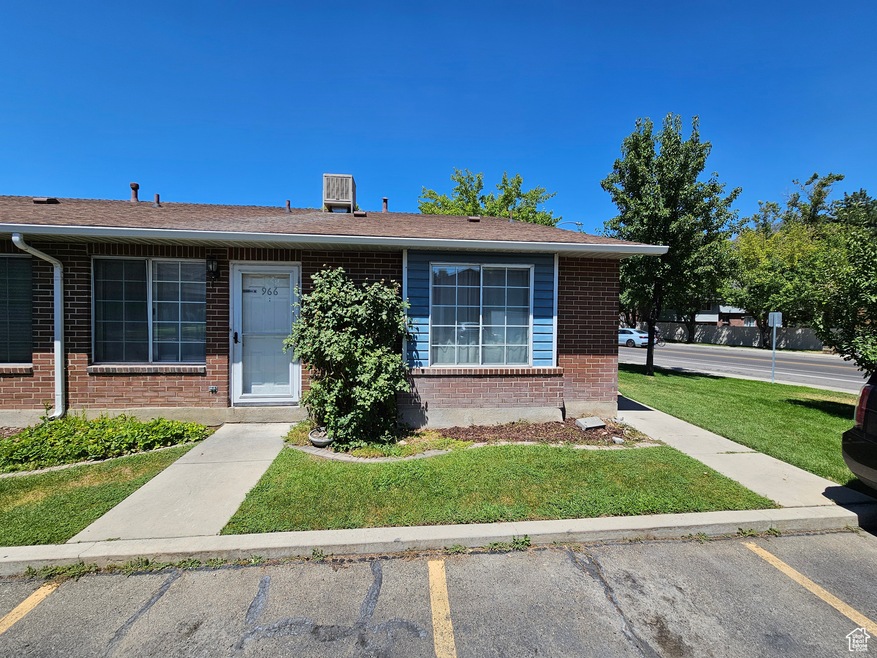 Ranch-style house with brick siding, a front lawn, and uncovered parking