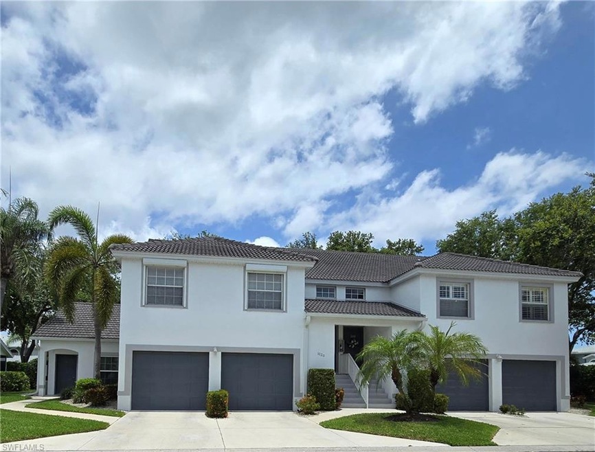 Mediterranean / spanish house with an attached garage, concrete driveway, a tile roof, and stucco siding