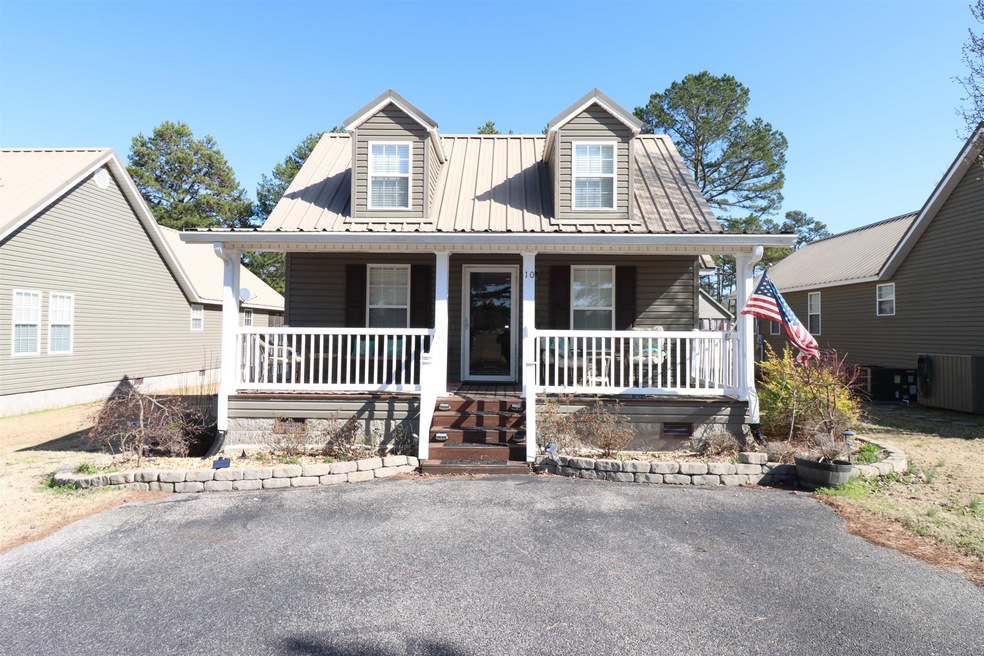 Cape cod home featuring a porch and metal roof