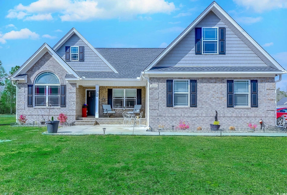 View of front of home featuring a front yard, cove