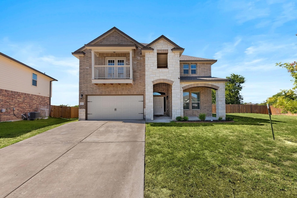 View of front of house featuring a garage and larg