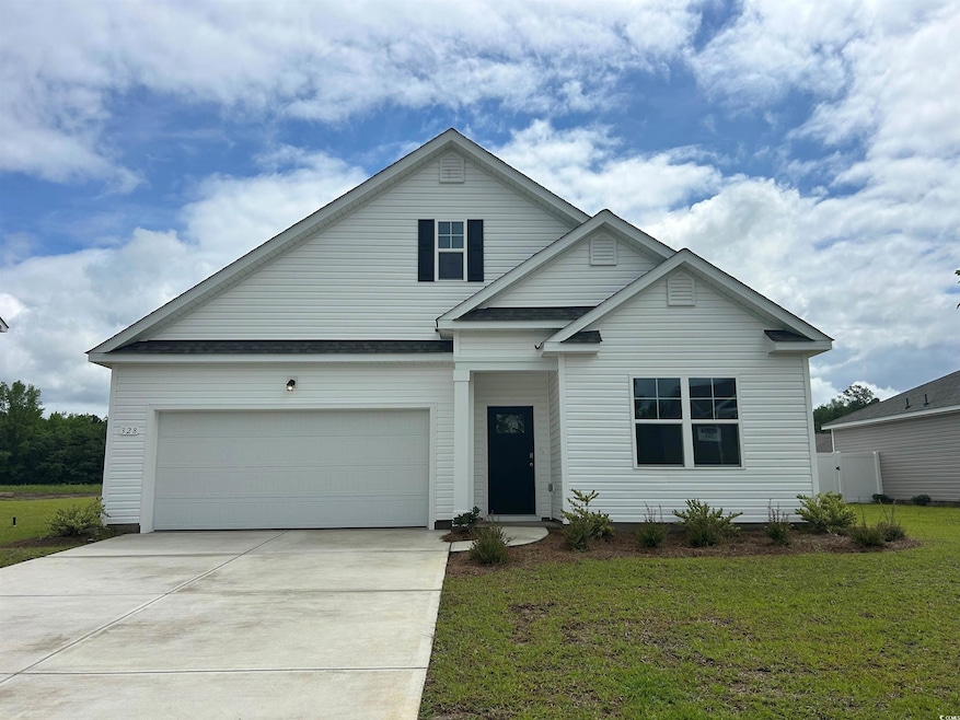 Traditional home featuring driveway and a front lawn