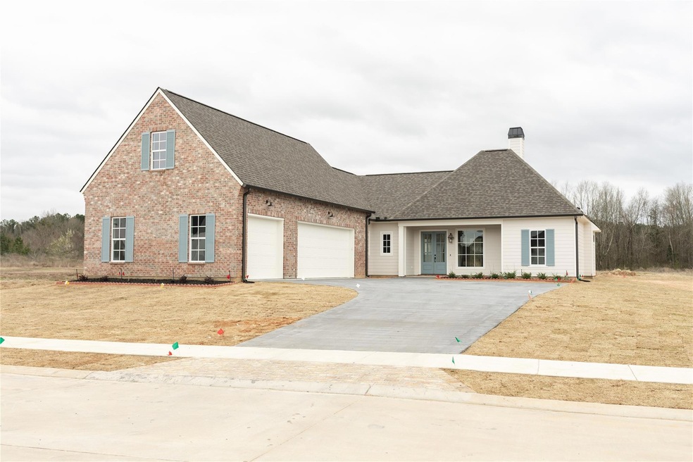View of front of property featuring driveway, roof