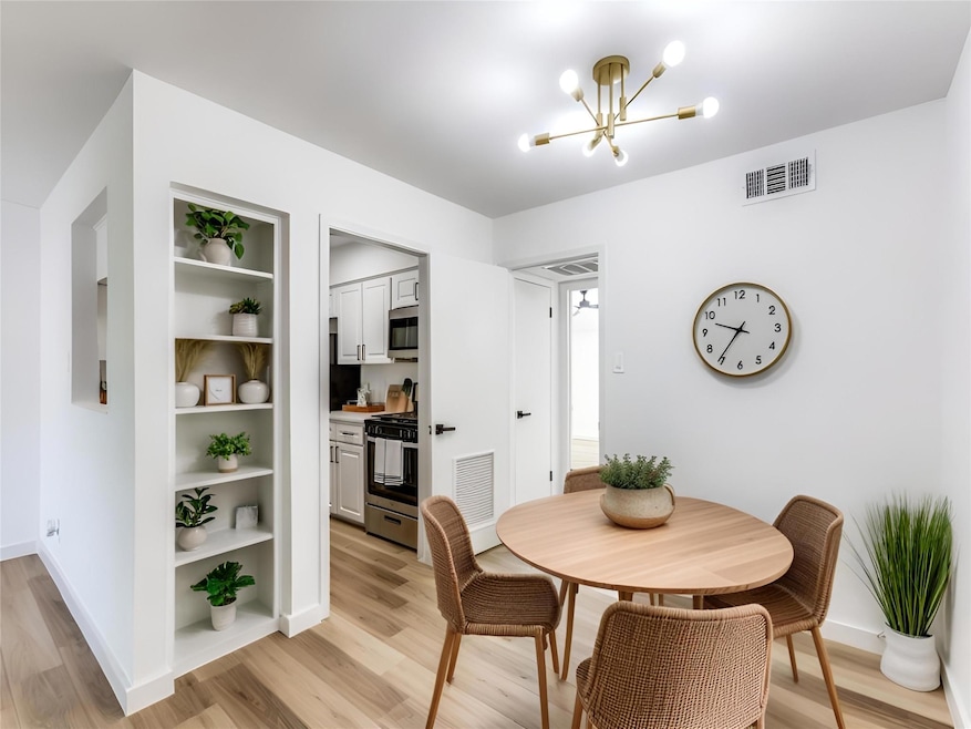 Dining room featuring a chandelier, light wood-st