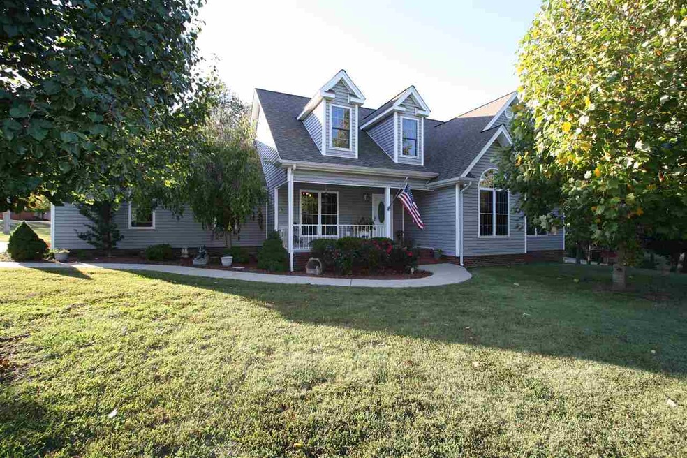Plush landscaping and a nice front porch adorn the