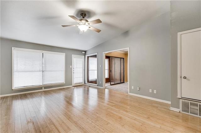 Spacious and well lit living room.  These high cei