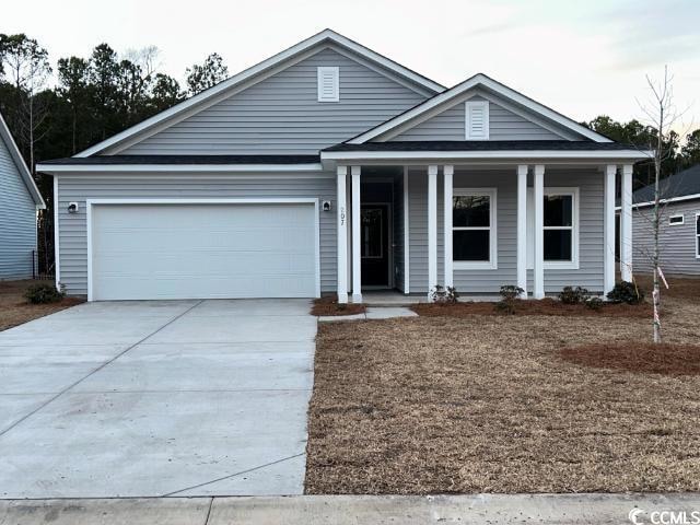 View of front of house with a garage and a porch