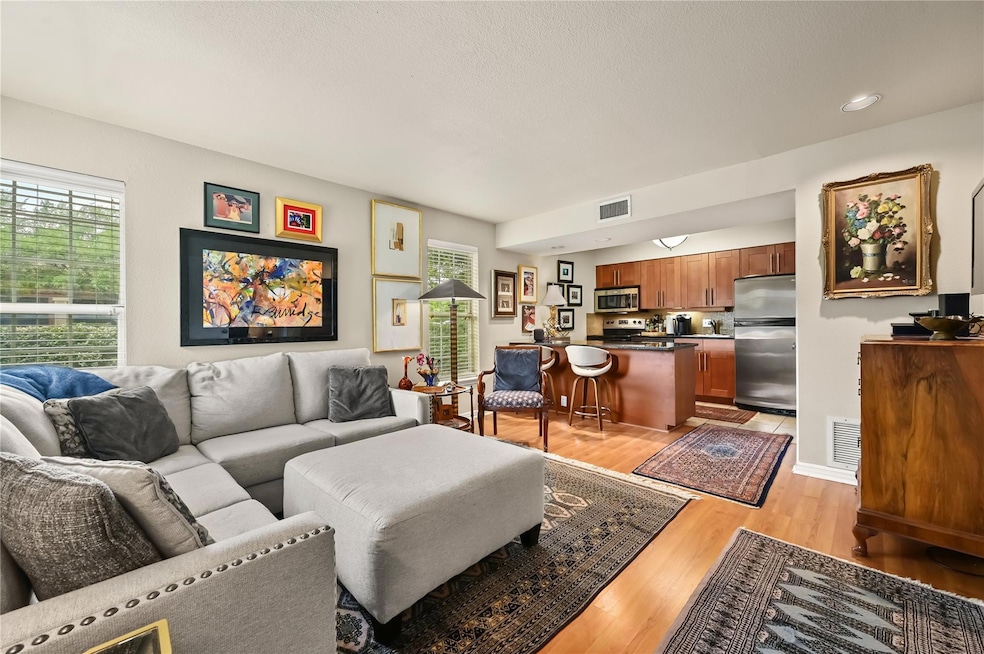 Living room with visible vents, plenty of natural