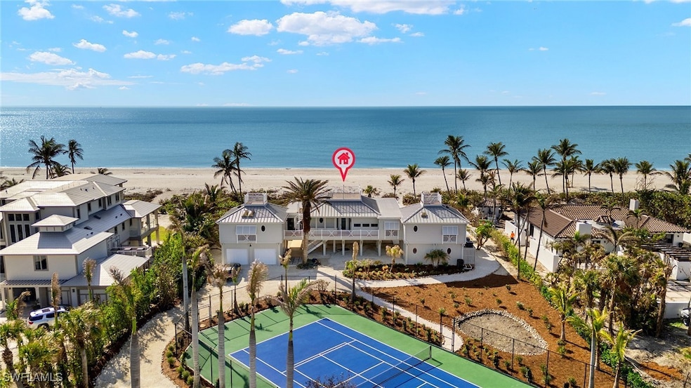 Drone / aerial view with a beach view and a water