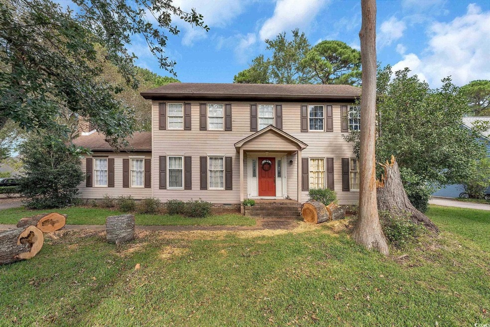 Colonial-style house featuring a front yard