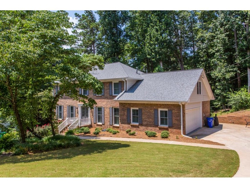 Classic 3-sided brick two story Dunwoody home on 4