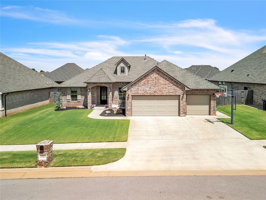 French country home featuring a front yard, brick siding, a shingled roof, and a garage