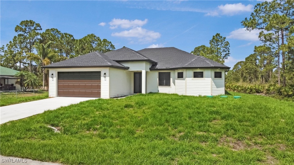 View of front facade featuring a garage, concrete