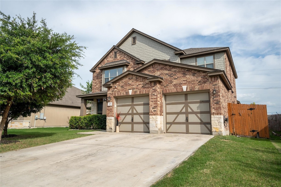 View of front of property featuring driveway, a g