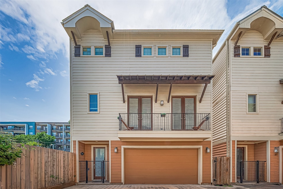 This is a modern, three-story townhouse with a lig