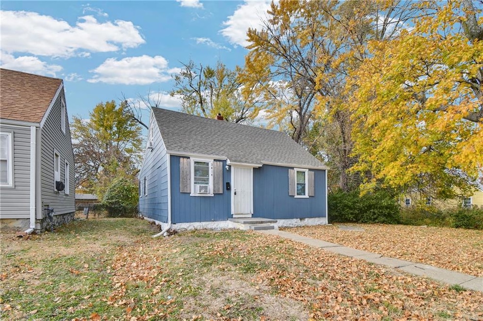 Bungalow featuring roof with shingles, a chimney, and a front lawn