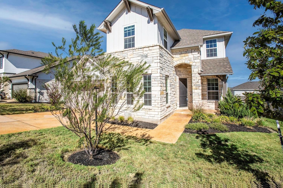 View of front of home with stone siding, board an