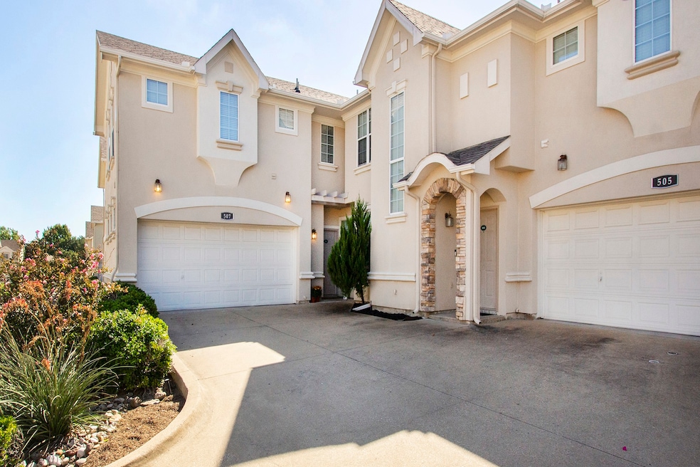 View of front of home featuring a garage, stucco siding, driveway, and stone siding