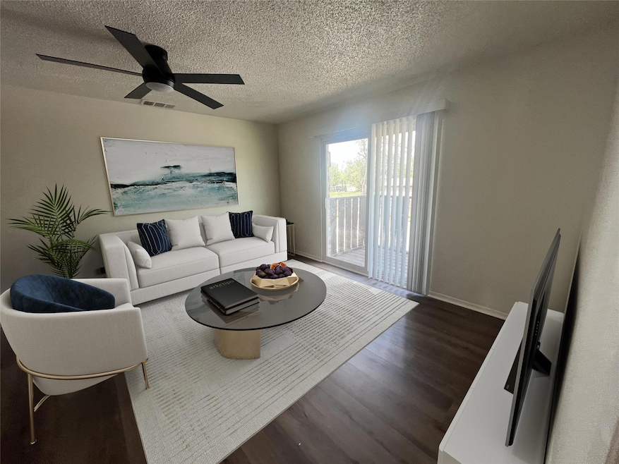Living room with dark wood-type flooring, visible 