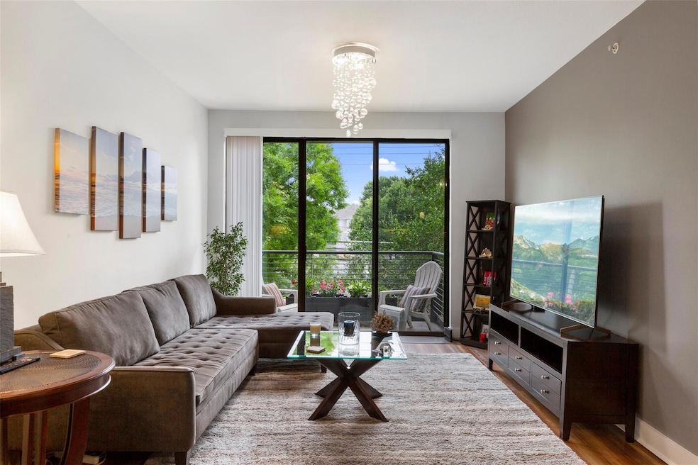 Living room featuring baseboards, wood finished fl