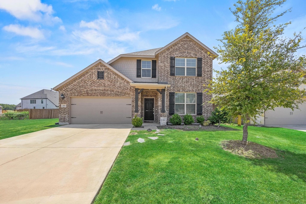 View of front of property featuring a garage and a