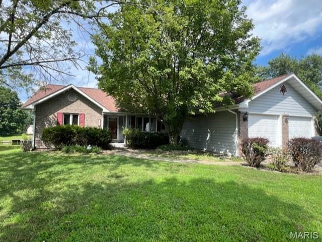 Ranch-style house with an attached garage, a front yard, and brick siding