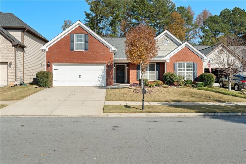 Traditional home with brick siding, concrete driveway, and a front yard