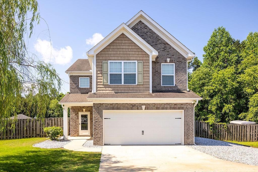 View of front of home with concrete driveway, an a