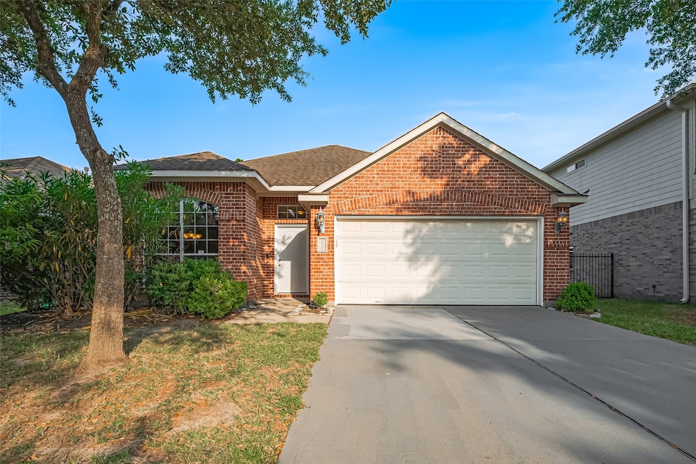 Crisp white garage and entry doors pop against the