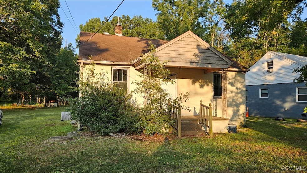 Rear view of property with a chimney, stucco sidin