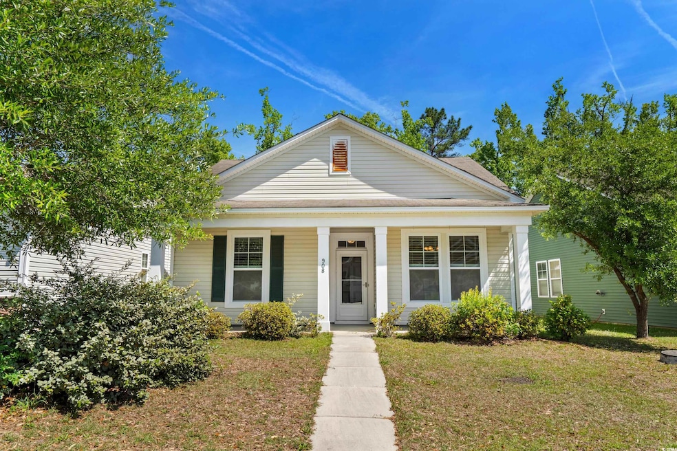 Neoclassical home with a porch and a front lawn