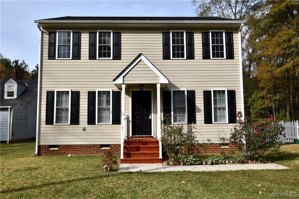 Colonial house with a nice front lawn and fenced rear yard