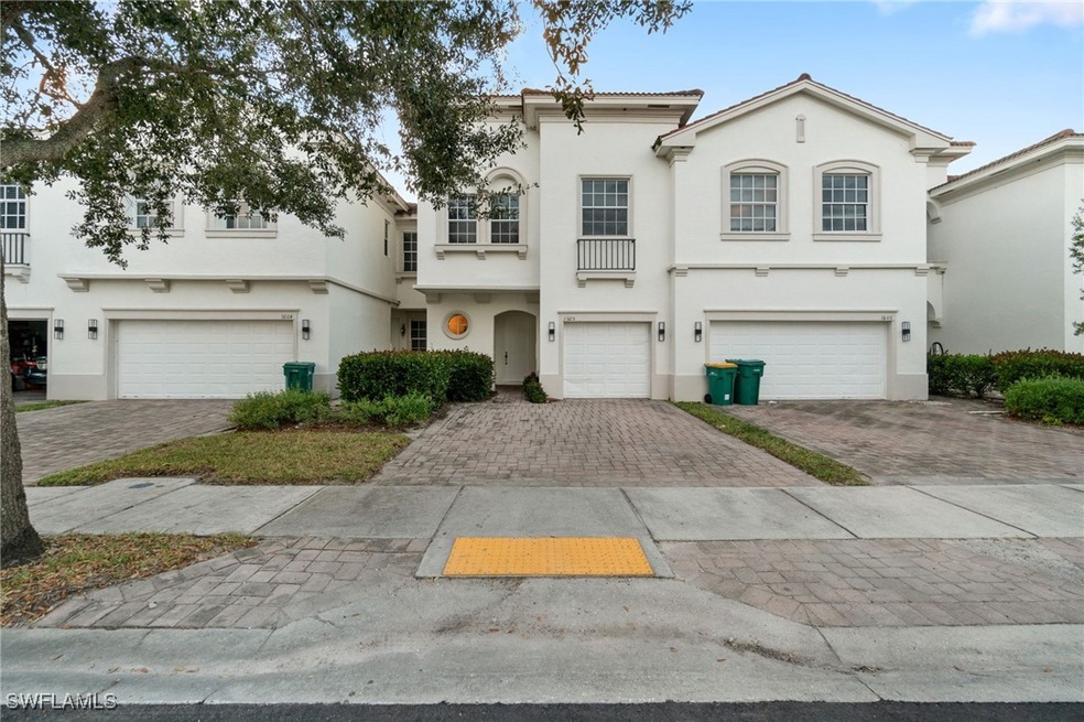 View of front of home with stucco siding, decorative driveway, and an attached garage