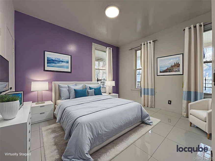 Bedroom with light tile patterned floors