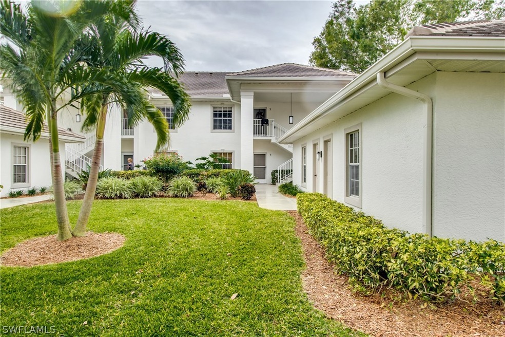 Beautiful landscaped front of condo building.