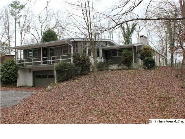 Two car garage parking on the lower level with a covered deck above.