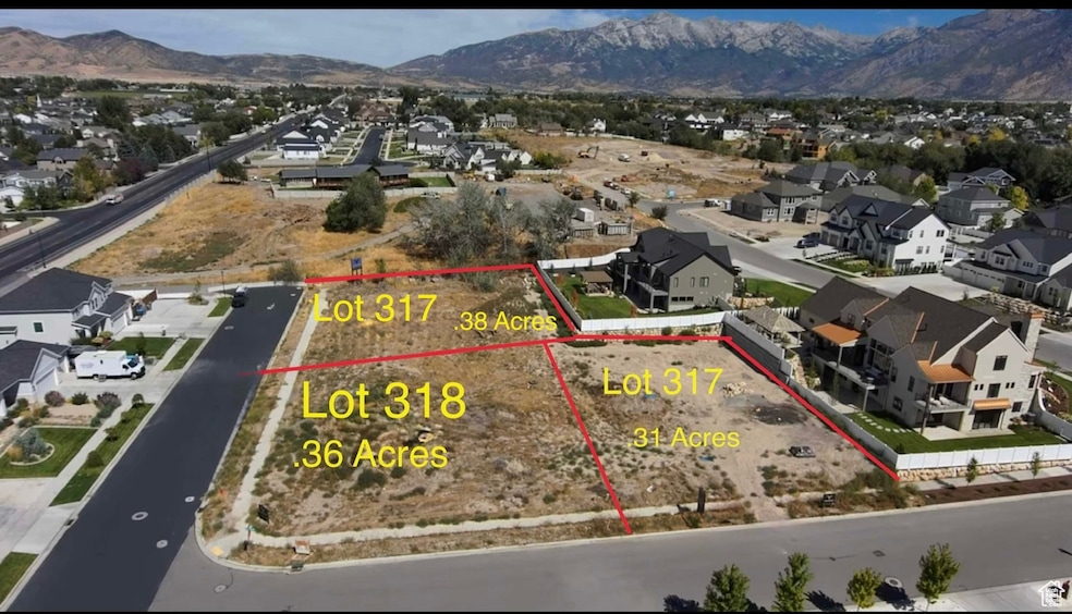 Aerial view of residential area with a mountain backdrop and property parcel outlined
