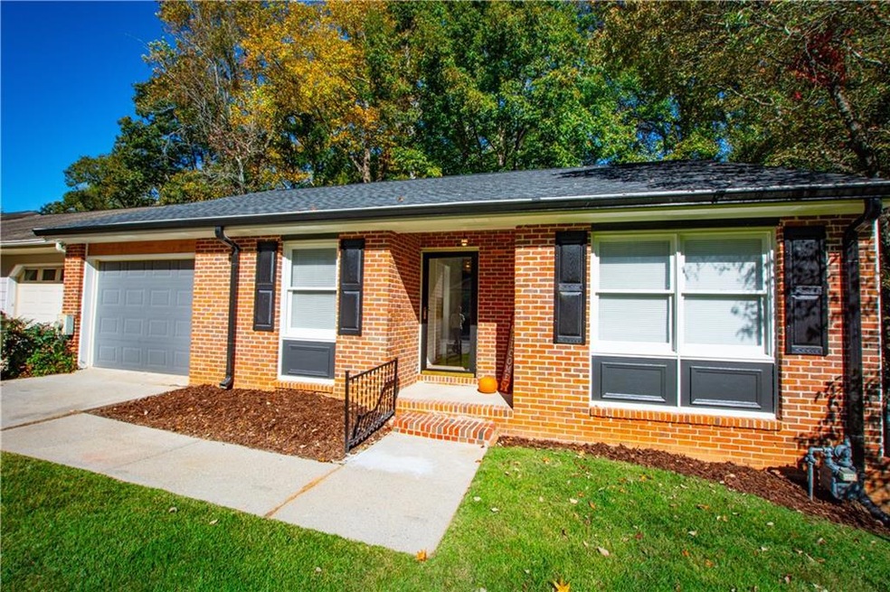 View of front of home with a garage and a front la