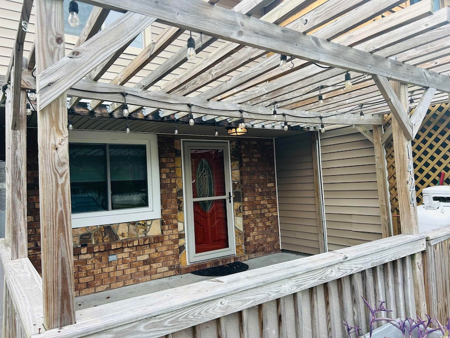 View of exterior entry featuring brick siding