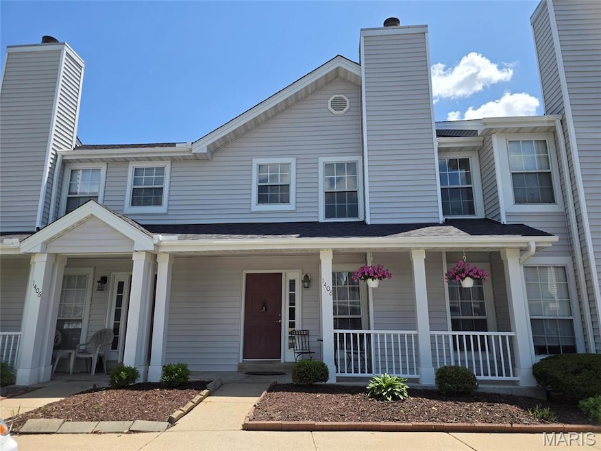 View of front of house featuring covered porch and a chimney